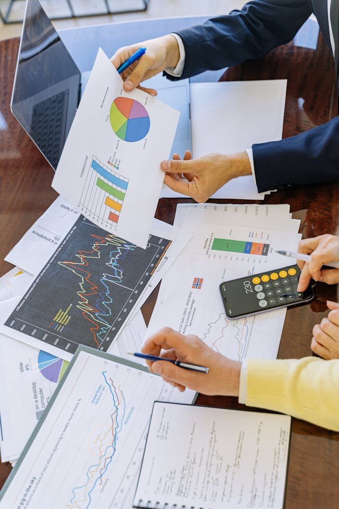 Business professionals analyzing financial charts and graphs during a meeting.